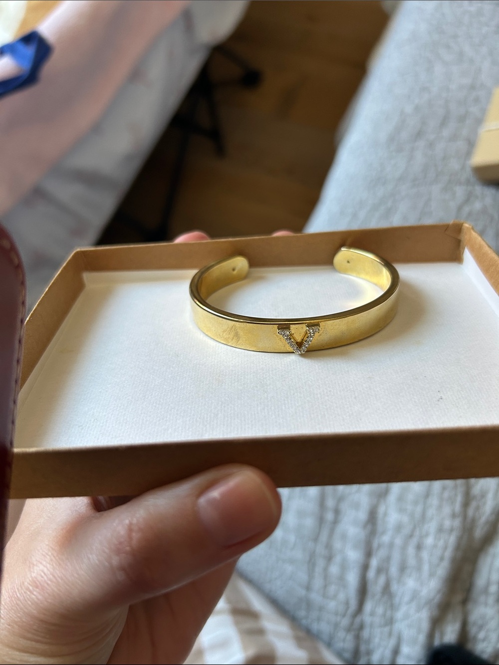 Gold Tone Cuff Bracelet with V Crystal Accent